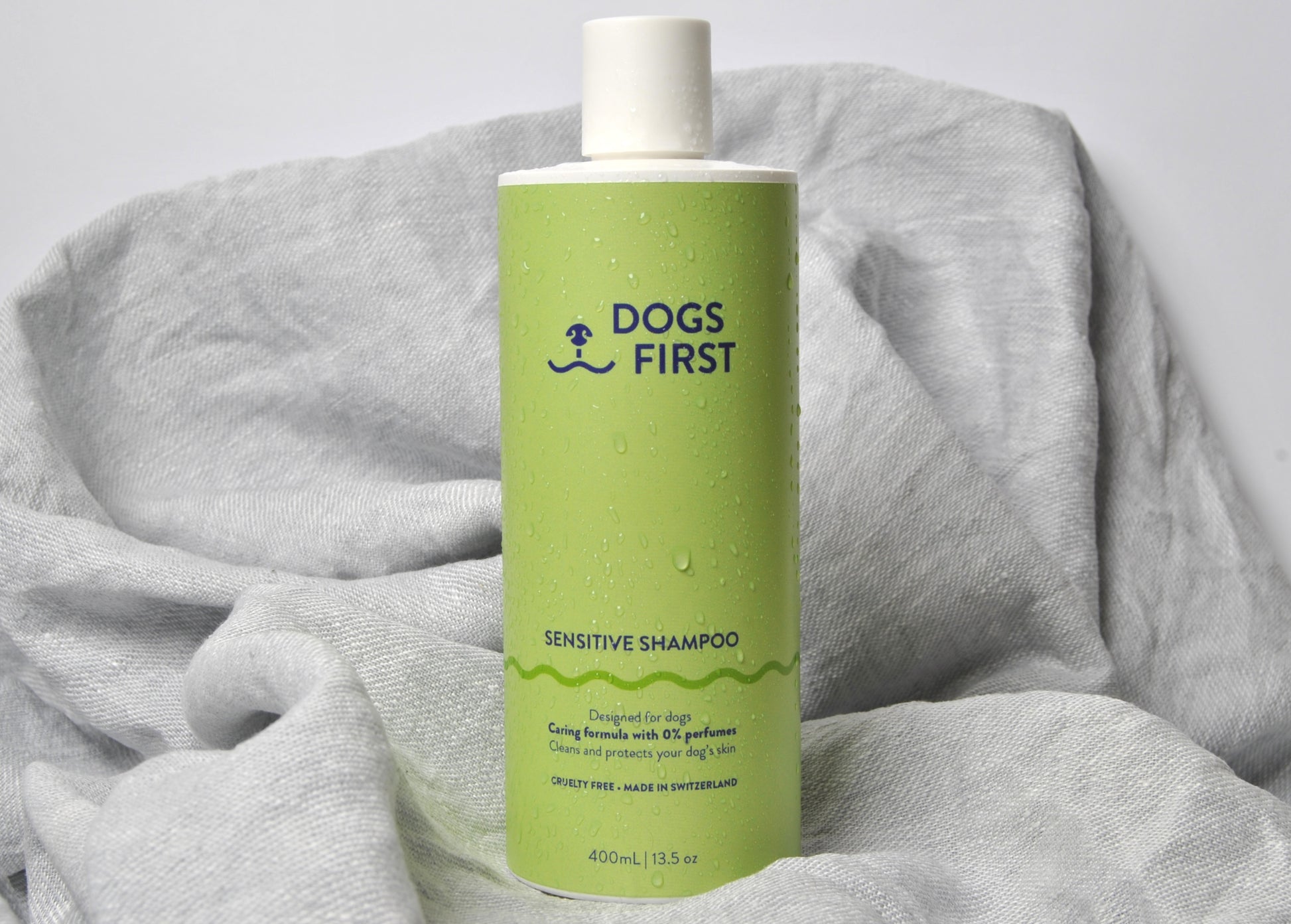 Dog shampoo bottle on grey towel - gentle sensitive skin formula made in Switzerland
