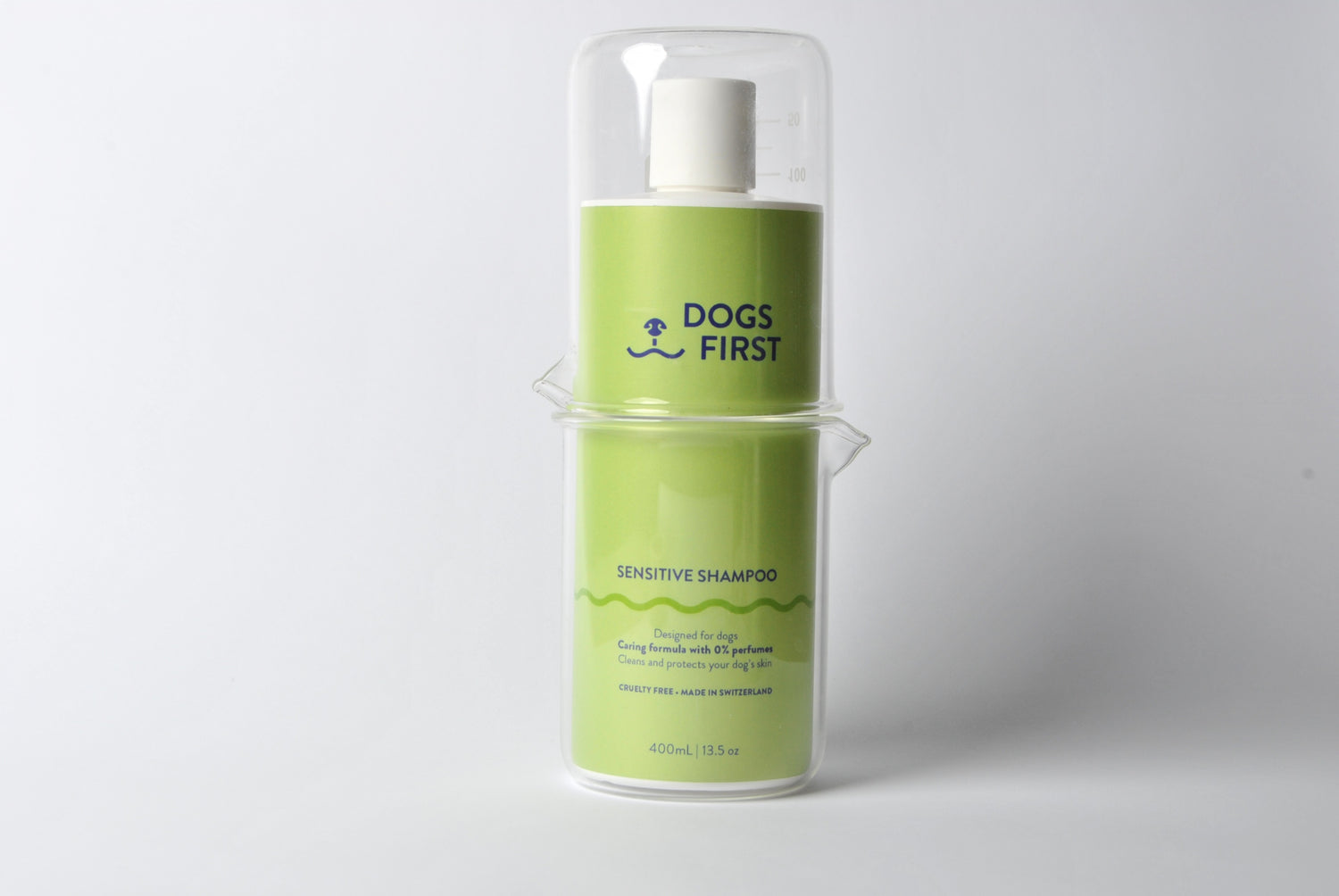 Bottle of dogs first dog shampoo inside two glasses. dog shampoo made in switzerland with caring formula.